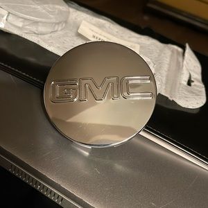 Gee… it’s a Set of GMC tire caps. New in pkg. Never installed.